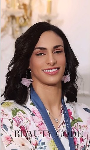 She poses in a pink floral outfit with matching earrings